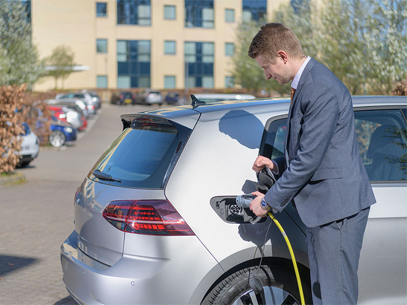 Man charging his electric car