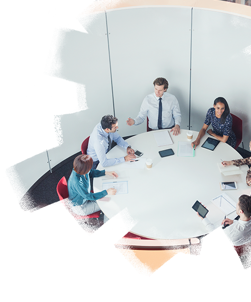 Employees having a round table conference inside a meeting room